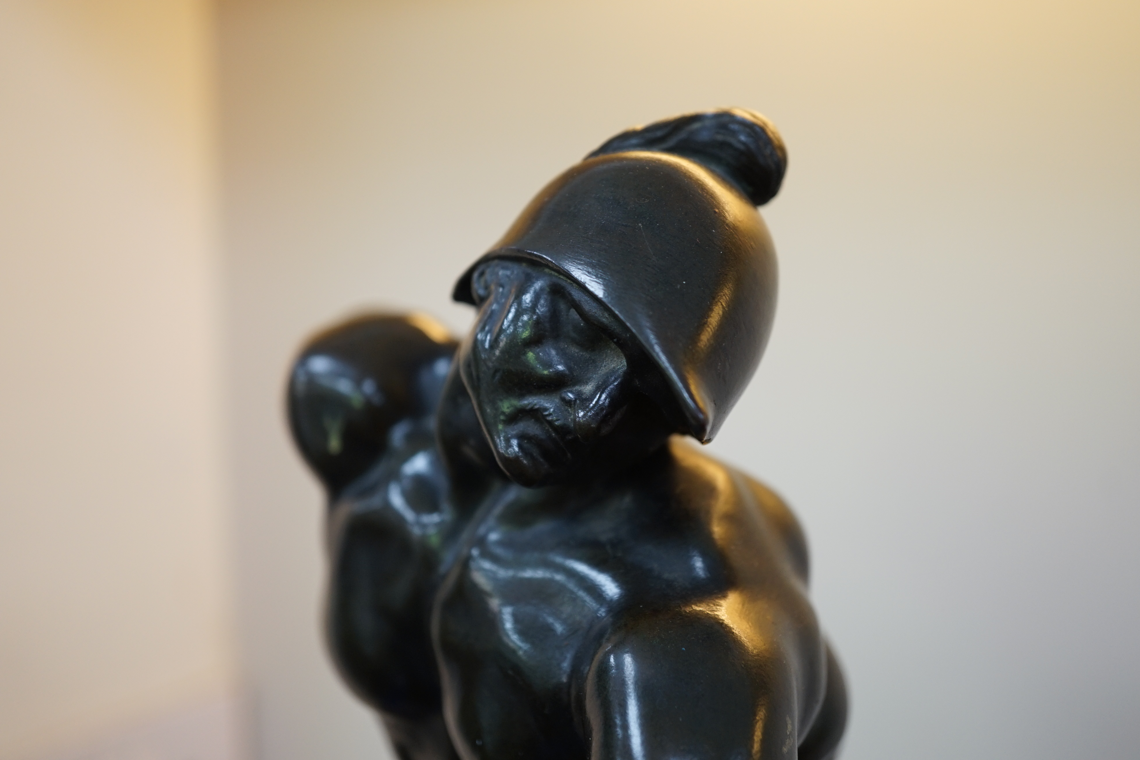 After the antique, a pair of late 18th/early 19th century Grand Tour souvenir bronze figures of seated warriors